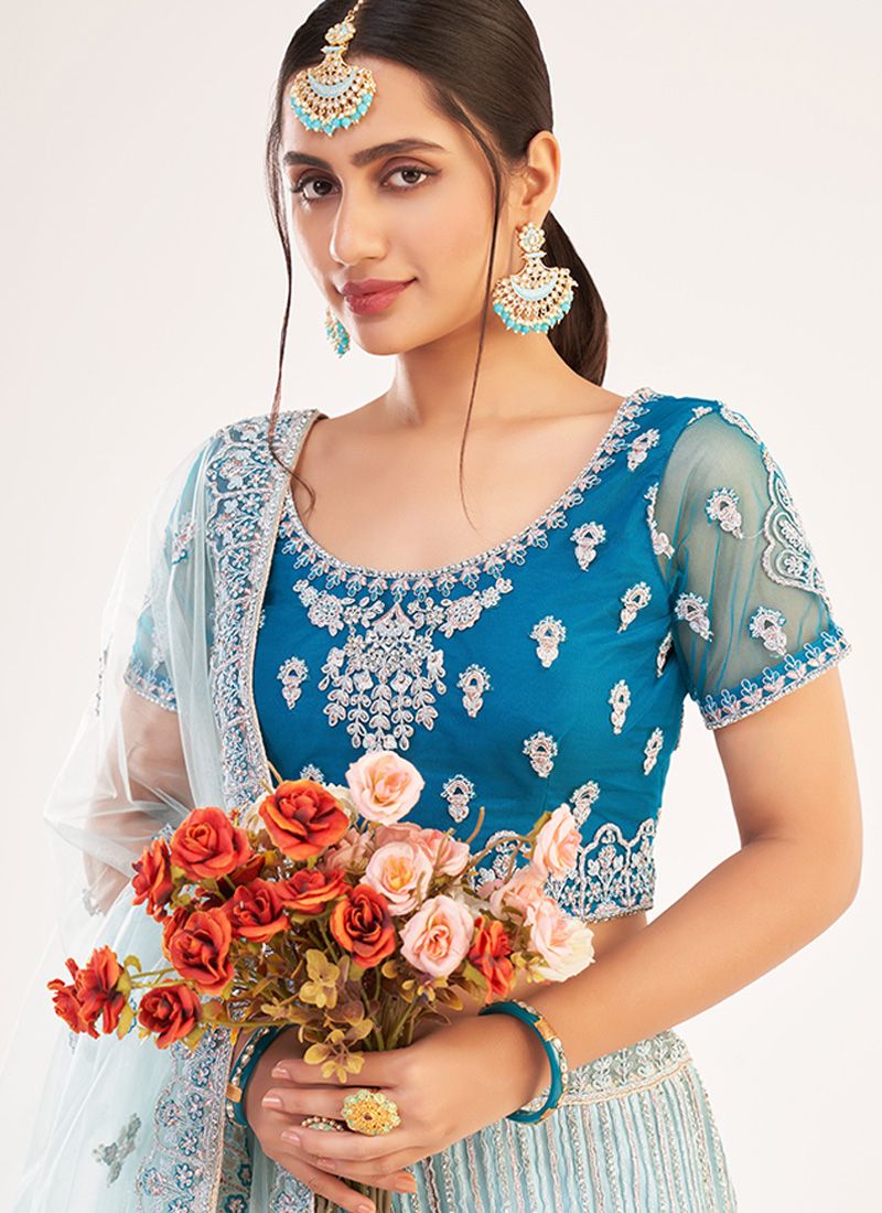 POWDER BLUE SHIMMERY SEQUIN LEHENGA SET WITH A COLOURED EMBROIDERED BLOUSE  PAIRED WITH A MATCHING DUPATTA AND A GOLD SCALLOPED BORDER. - Seasons India